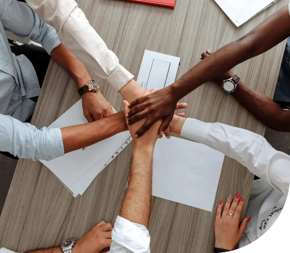 A group of people looking at a laptop.